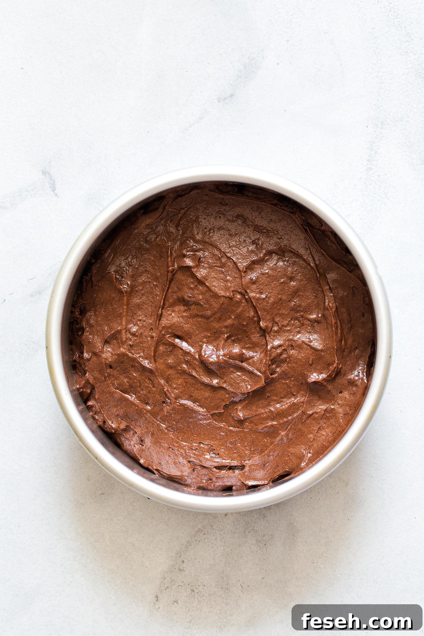 Unbaked chocolate cake batter in pan