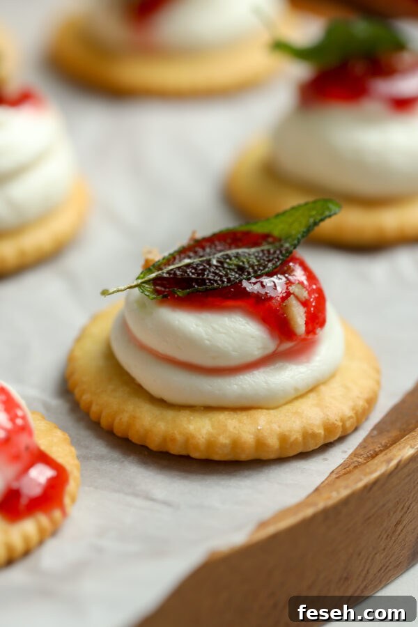 A Ritz cracker topped with a goat cheese and cream cheese blend.