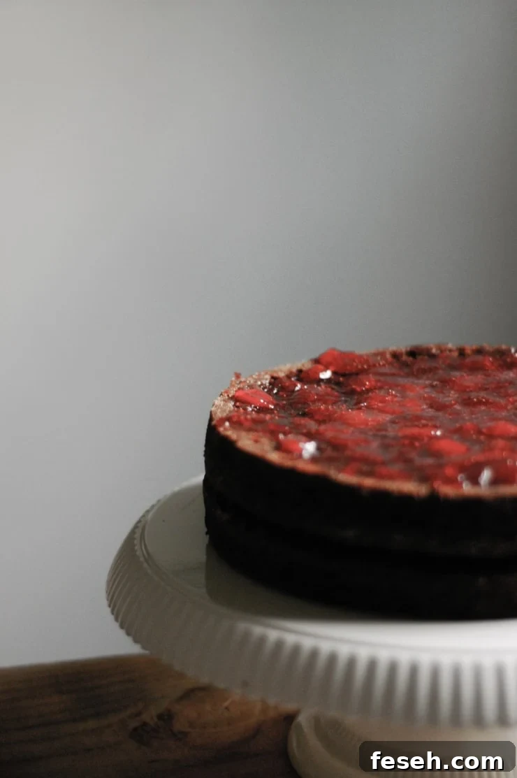A moist and delicious strawberry and chocolate cake recipe with a decadent chocolate frosting. This chocolate layer cake is perfect for all celebrations! | sophisticatedgourmet.com