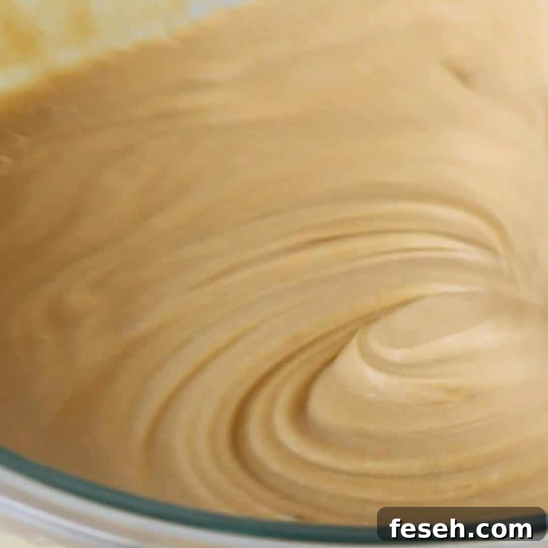 Smooth biscoff brownie batter in a glass bowl, whipped to perfection, ready to be baked into decadent biscoff-flavored brownies.