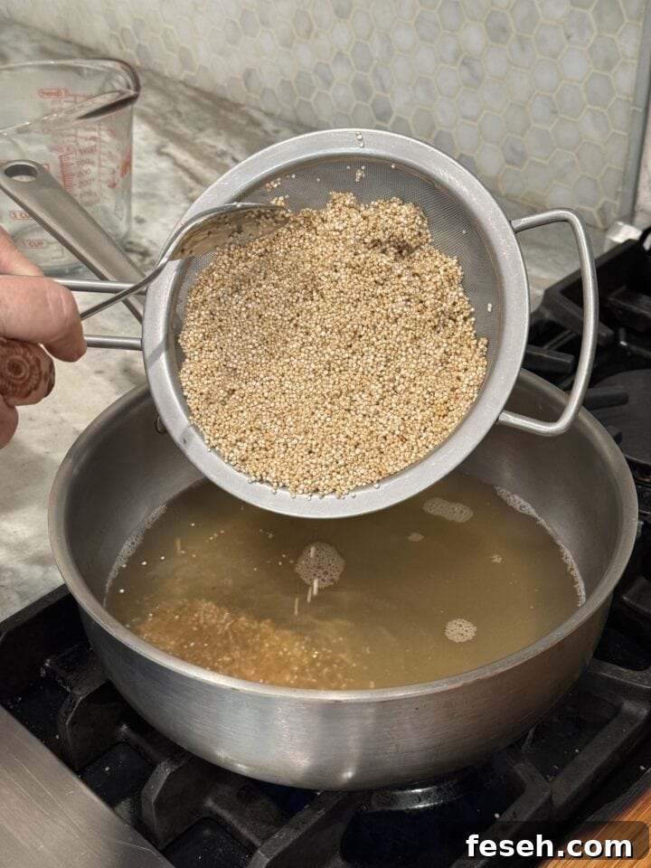 a photo of quinoa going into a pot of chicken broth
