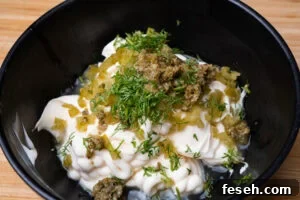 Mayonnaise, chopped capers, Gerkin and dill in a bowl with lemon juice