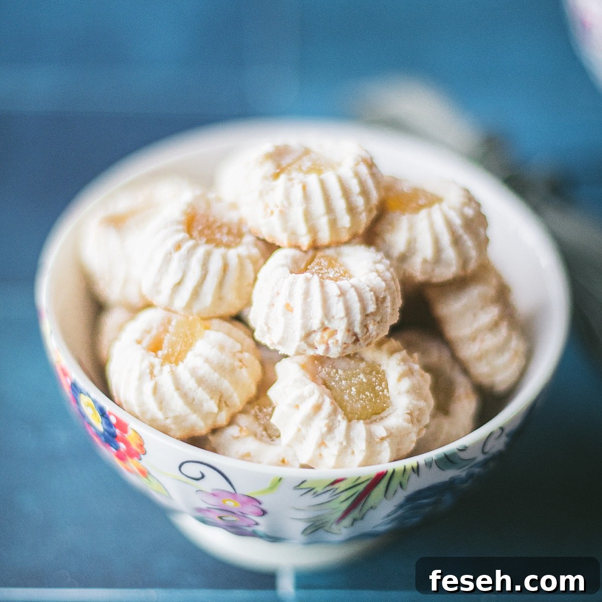 super simple square photo of Indonesian Butter Pandan cookies on blue tile background