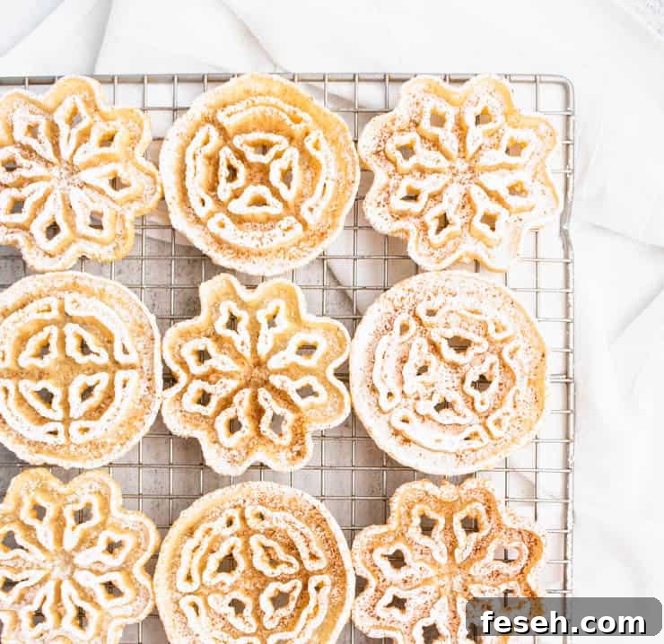 Powdered sugar dusted rosettes on a gold cooling rack.