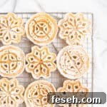 Powdered sugar dusted rosettes on a gold cooling rack.