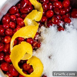 cranberries and lemon peel and white sugar in a pot