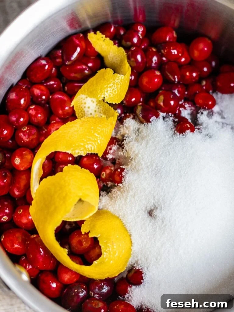 cranberries, lemon peel, white sugar in a pot for homemade cranberry sauce