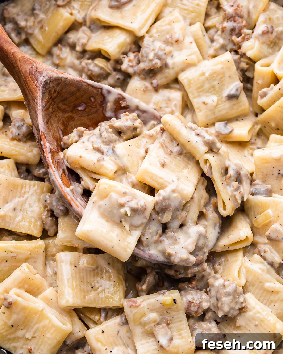 Large wooden spoon with paccheri alla norcina.