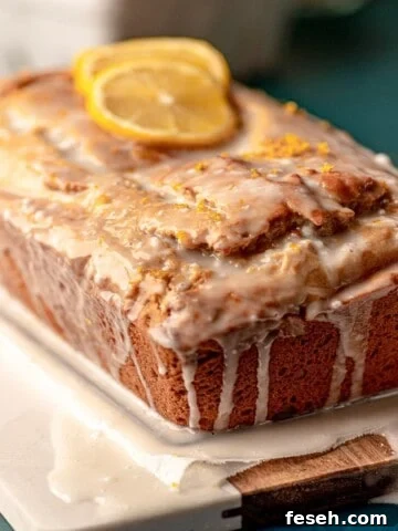 Lemon drizzle cake topped with lemon slices.