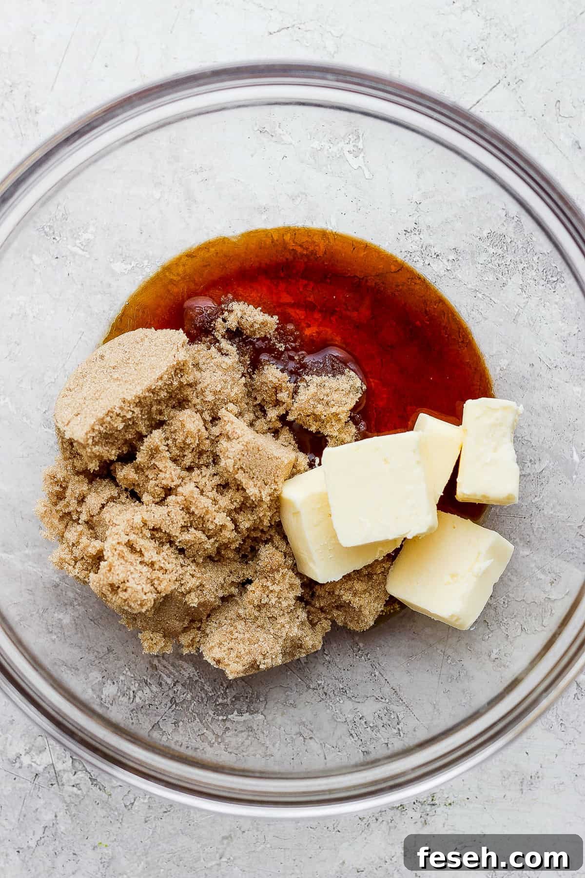 a bowl filled with butter and sugar.