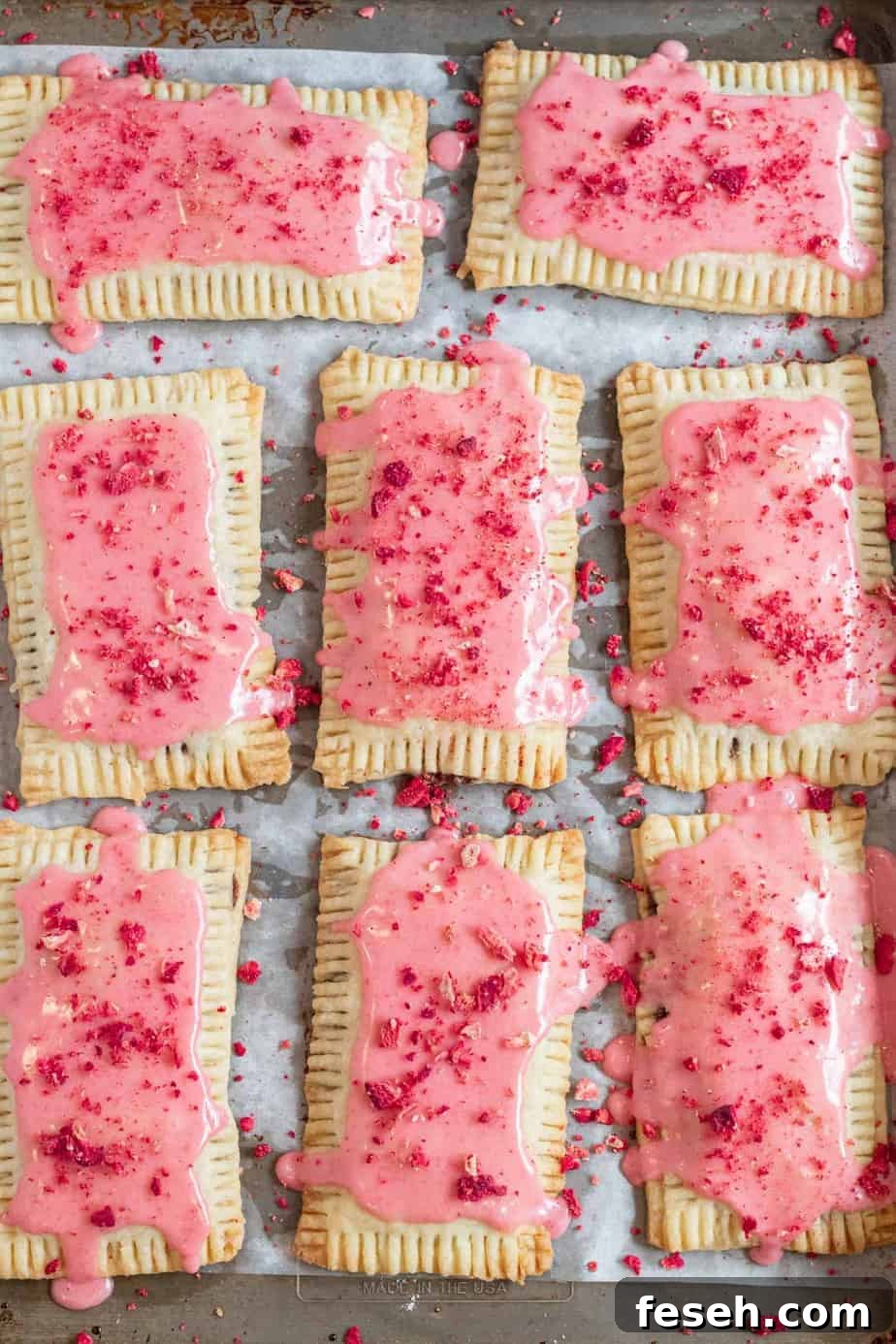 pop tarts with strawberry glaze on baking sheet