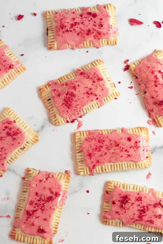 chocolate pop tarts with strawberry glaze on a white marble counter