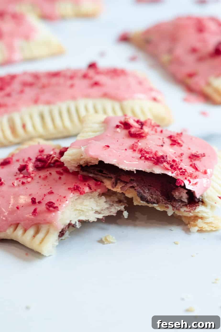 chocolate pop tart cut in half with strawberry glaze on top