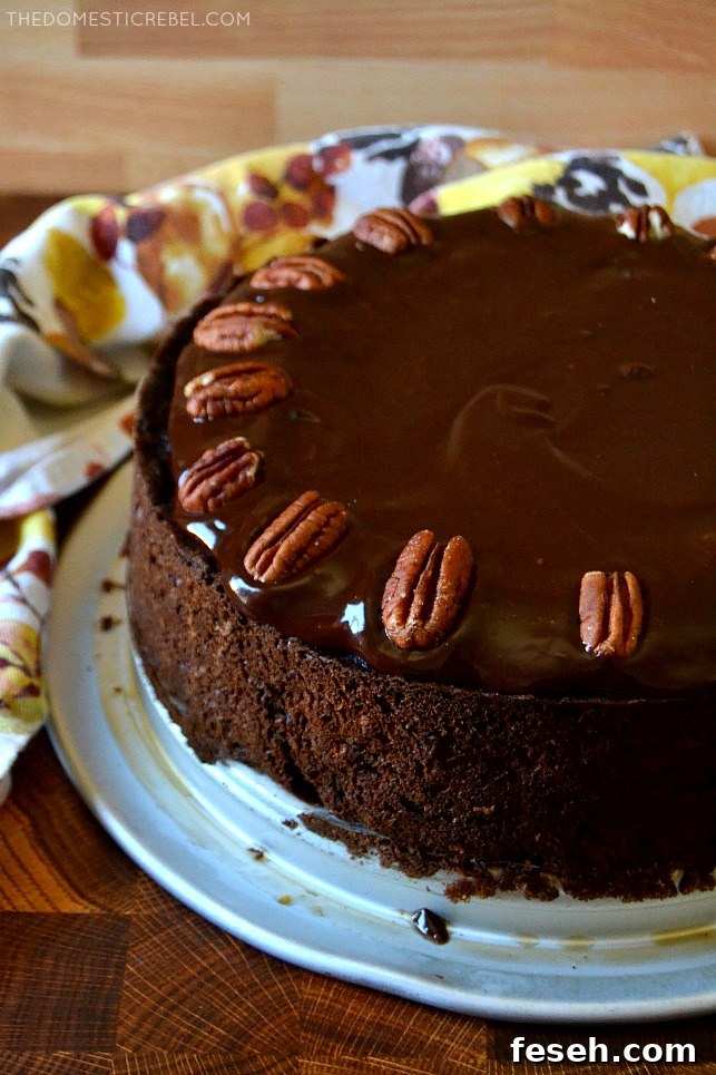 A whole chocolate pecan piecaken on a silver tray