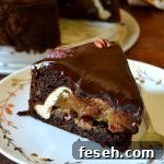 Slice of chocolate pecan piecaken on white plate