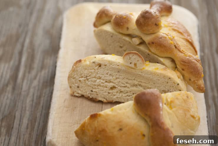 Slices of traditional Pan de Muerto bread with bone-shaped dough decorations, served on a rustic wooden board.