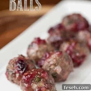 a platter of beef cocktail meatballs with cranberry sauce