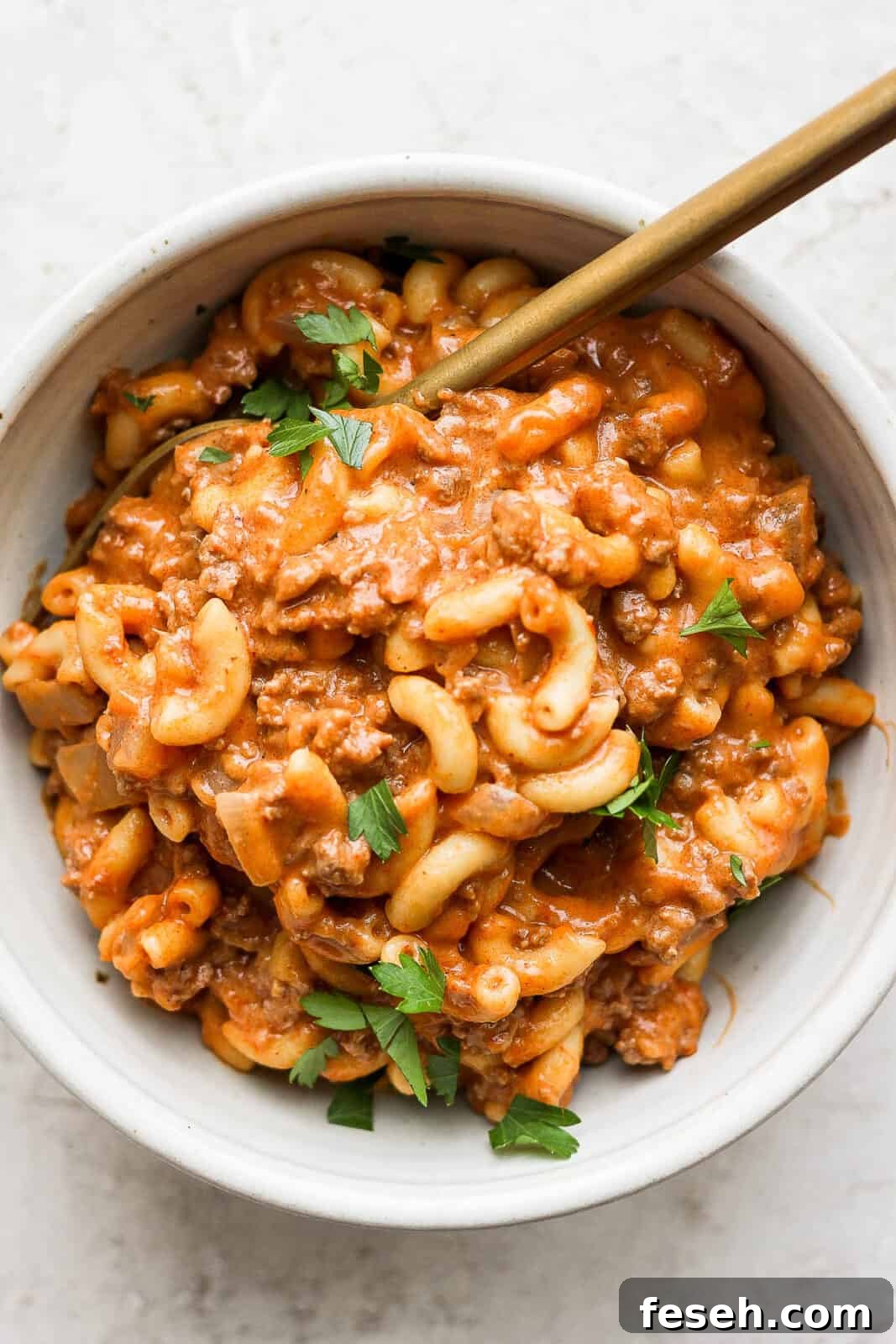 Healthy Hamburger Helper in a bowl with a spoon.