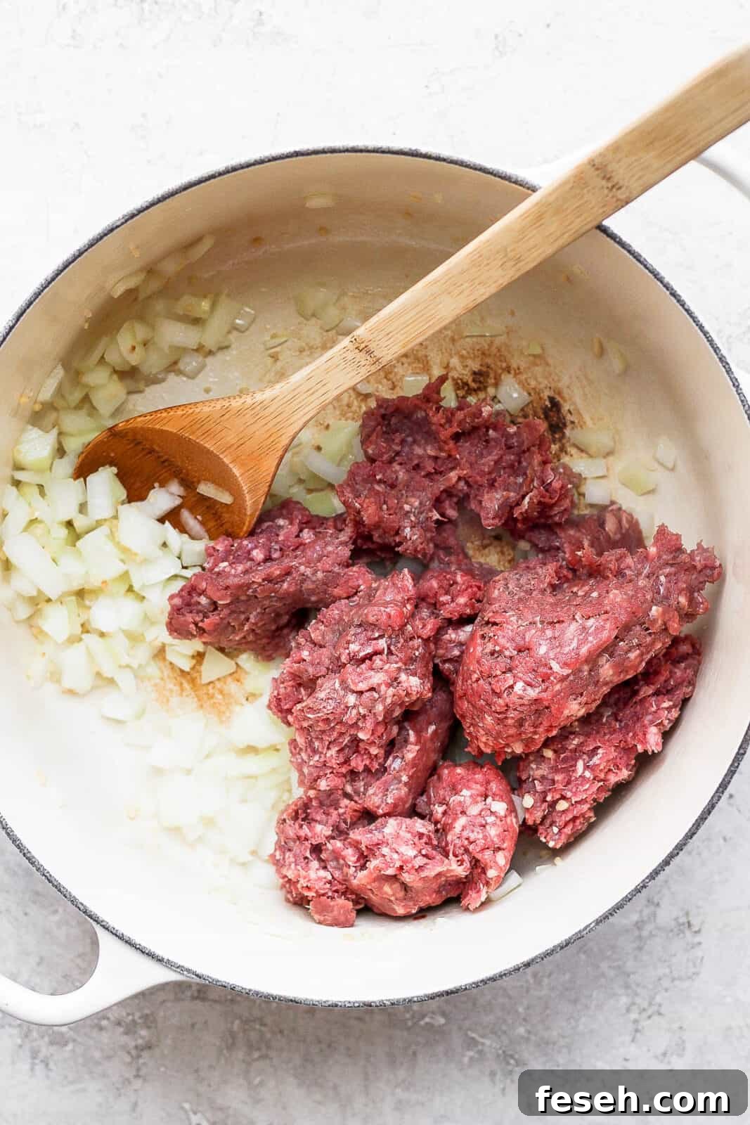 Onion, garlic, and ground beef in a dutch oven.