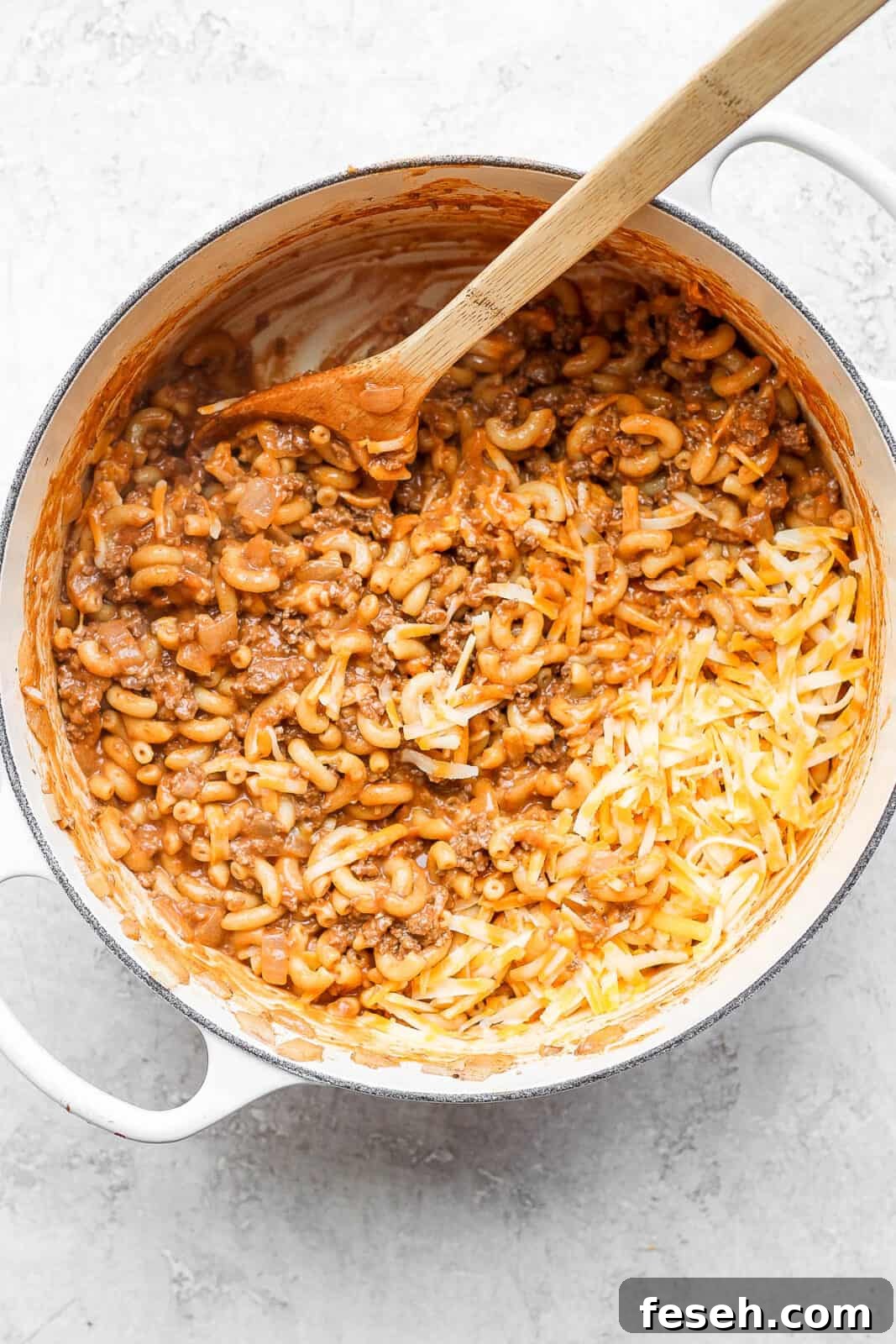 Cheese added to the pot of hamburger helper.