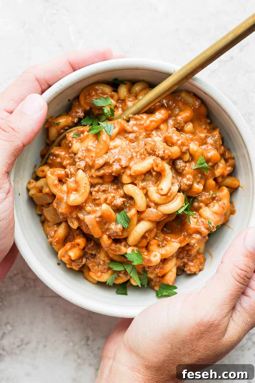 Healthy hamburger helper in a bowl with a spoon.