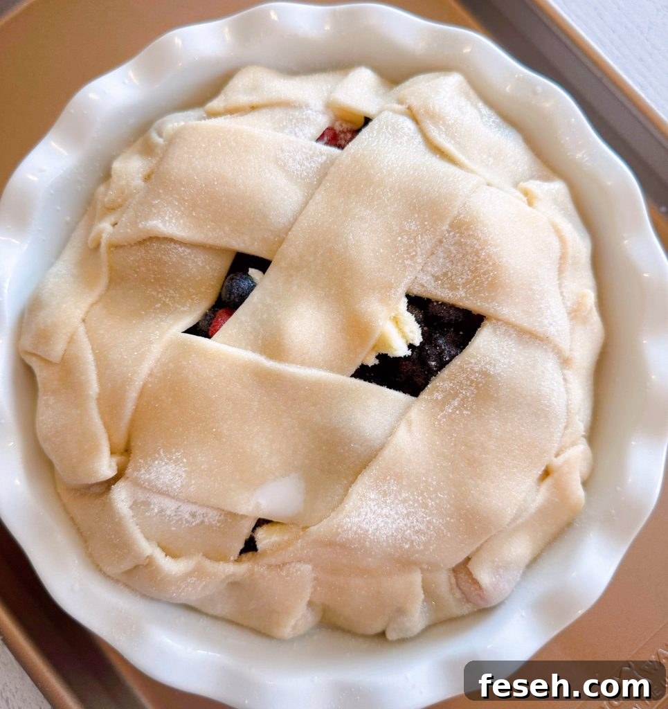 Pie on a lined baking sheet ready to go into the oven.