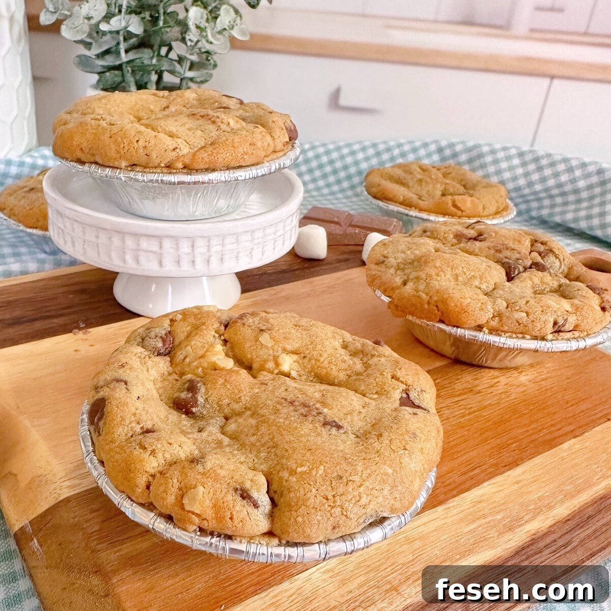 Mini S'more Chocolate Chip Pies on a small cutting board and cake stand.