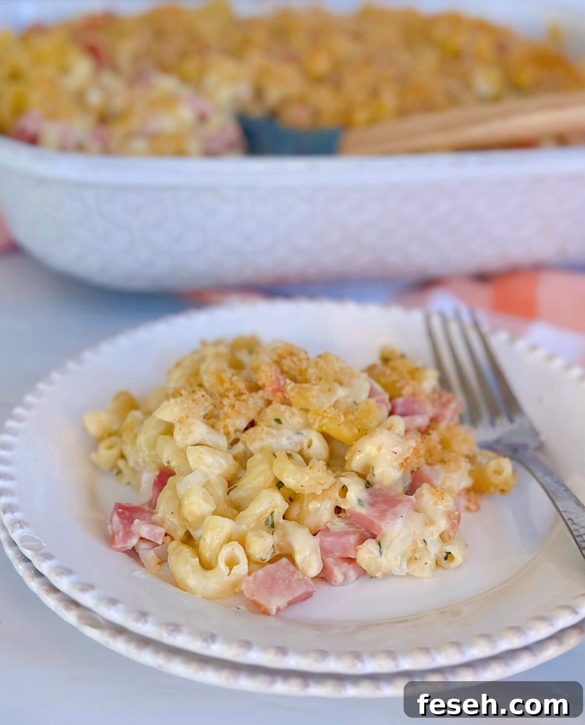 Creamy Ham and Noodle Casserole on a stacked dinner plate.
