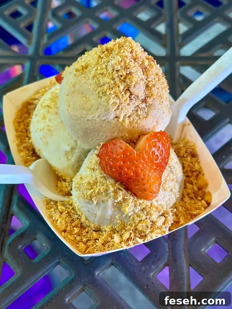 MOSA! three scoops of ice cream topped with peanuts and fresh strawberries.