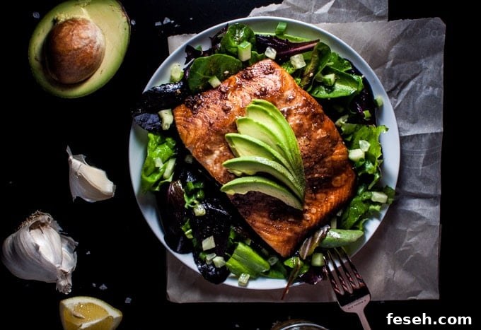 plate with healthy salmon salad with toasted sesame dressing and a fork