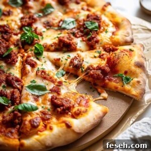 Chorizo pizza with cheese and basil.