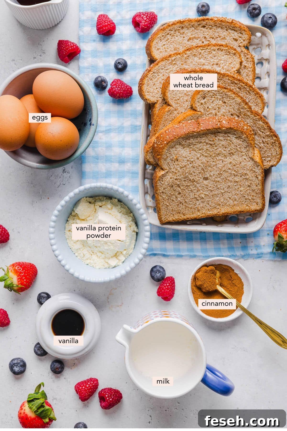 All of the ingredients for high protein french toast in bowls on a white countertop.