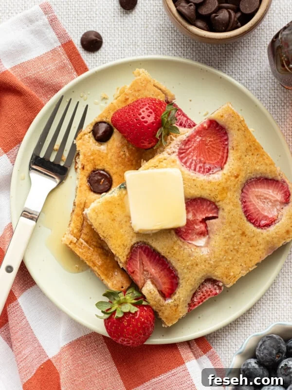 Sliced sheet pan protein pancakes on a plate with butter.