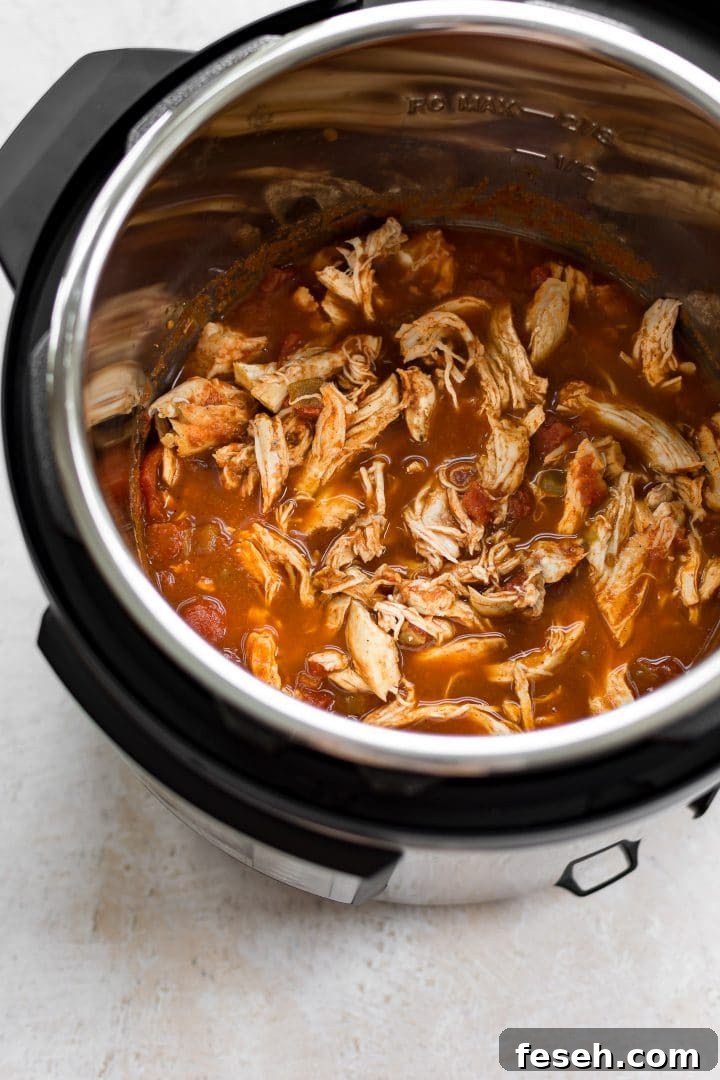 an Instant Pot filled with shredded chicken for tacos
