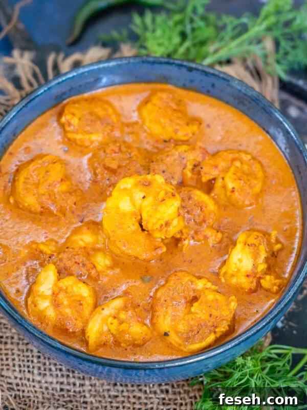 A black bowl filled with Goan Prawn Curry.