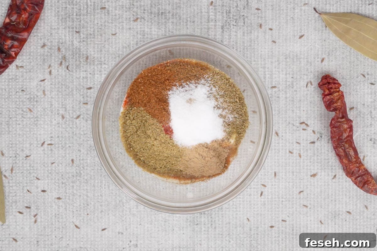 Yogurt and powdered spices added in a bowl.