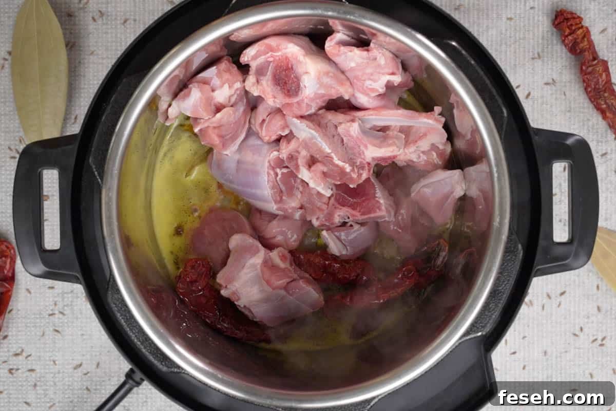 Lamb added to the pot.