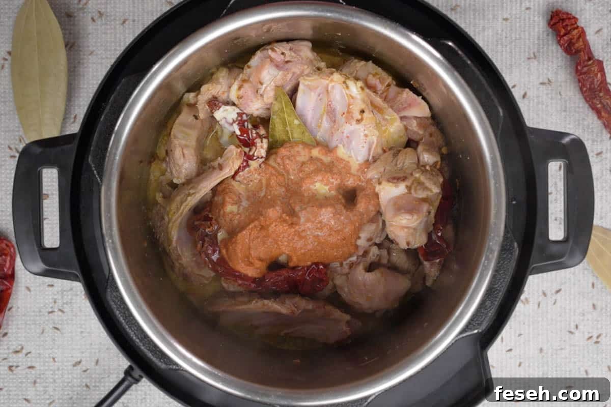 Yogurt mixture and saffron soaked in milk added to the pot.