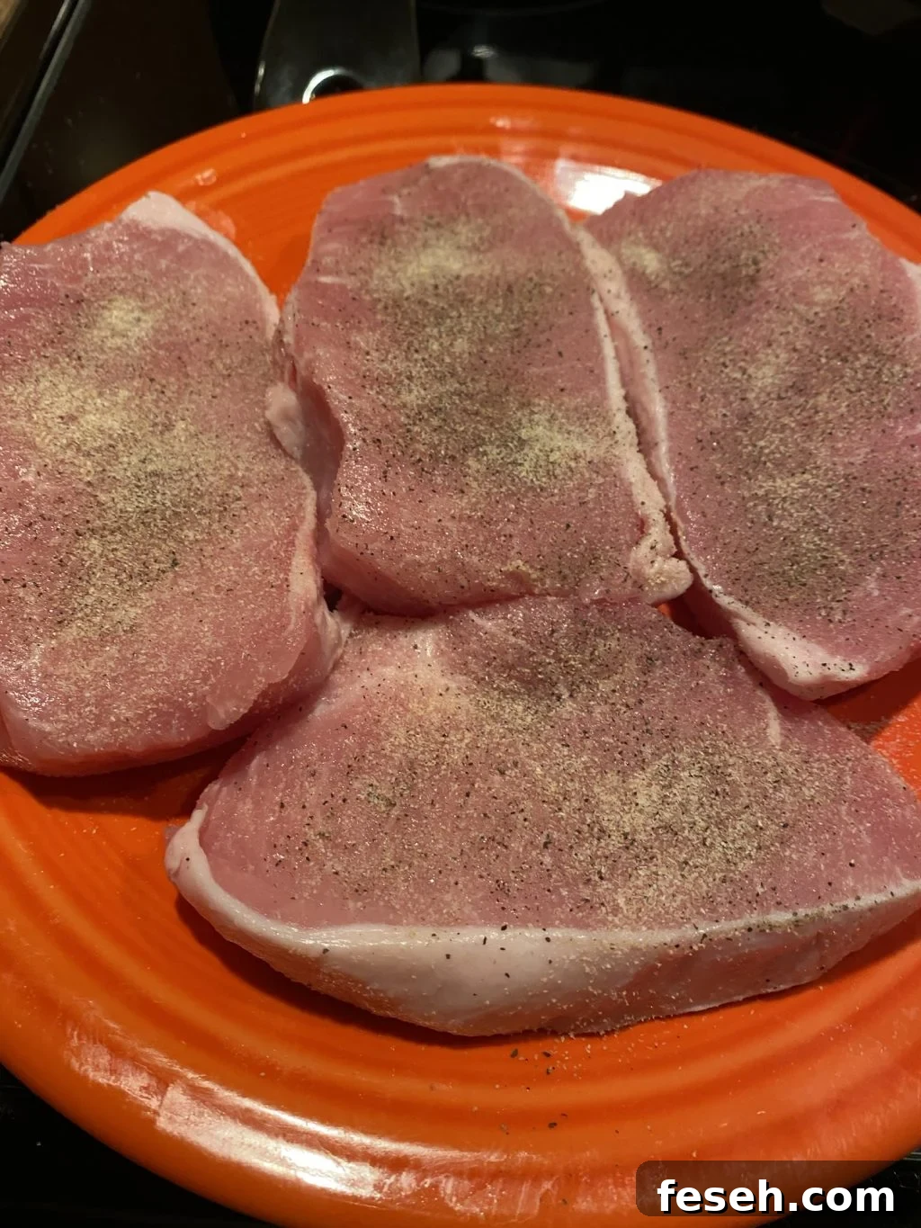 Raw, seasoned pork chops