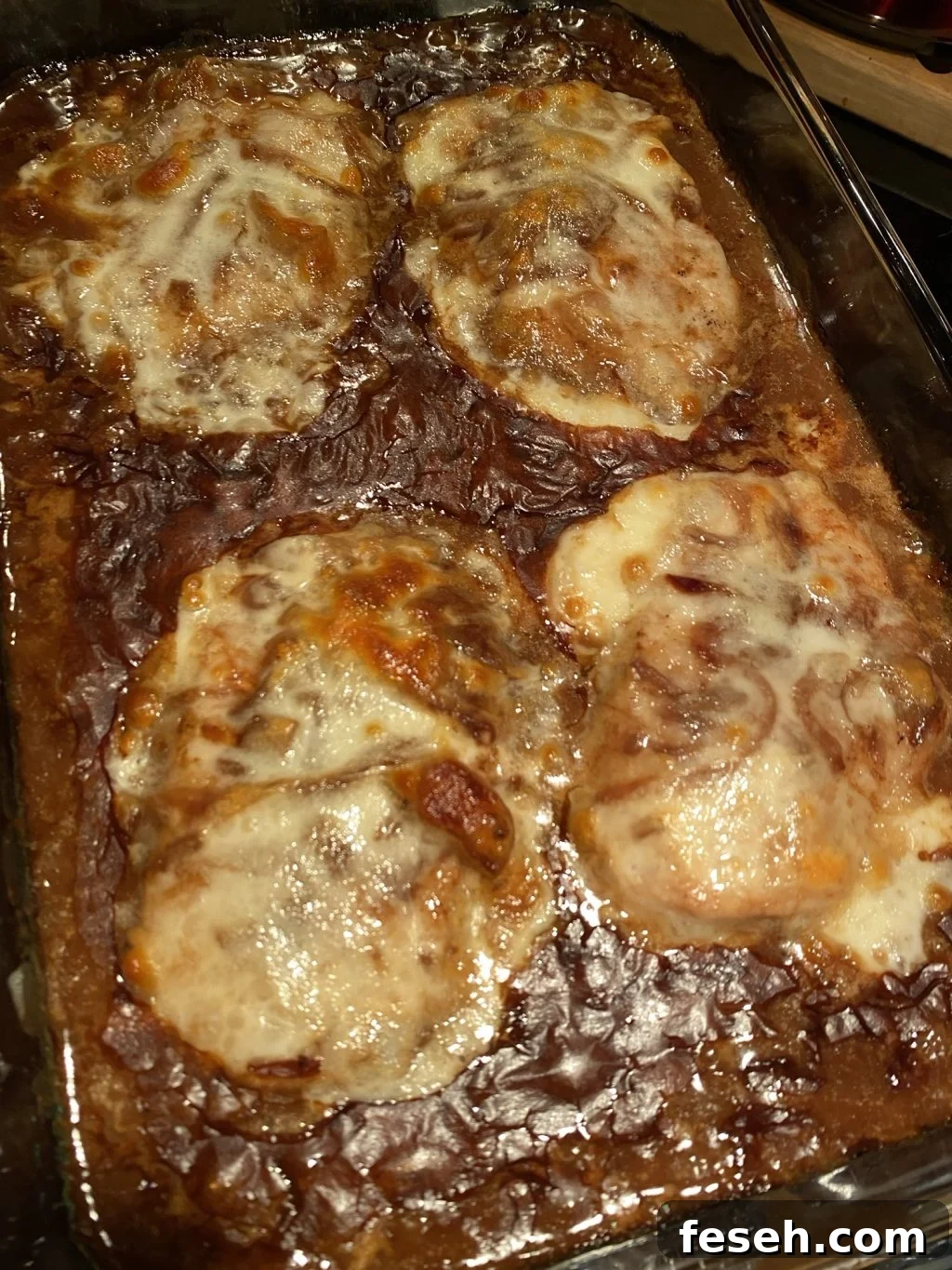 Finished French Onion Pork Chops in a baking dish
