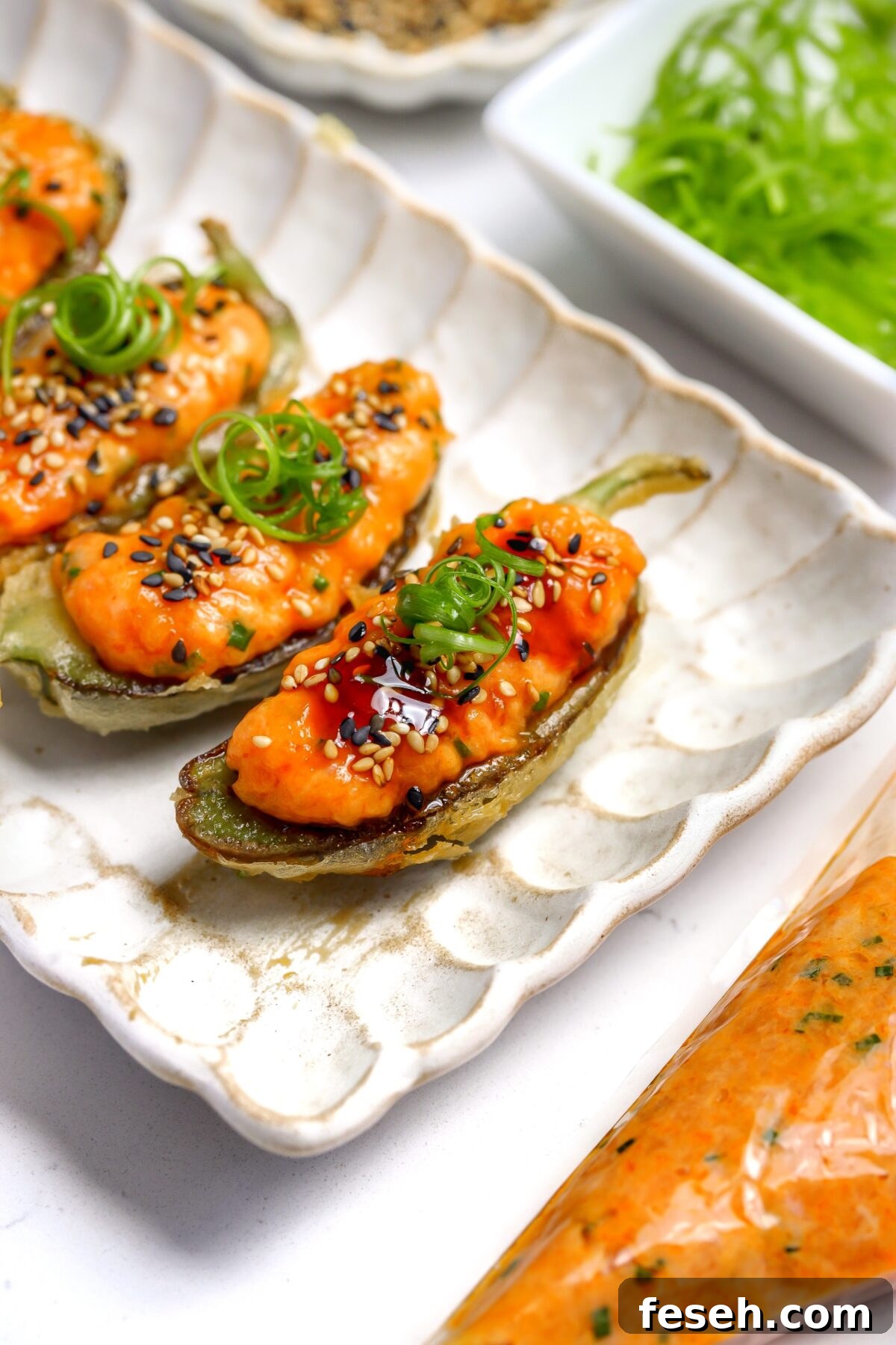 A recipe for tempura coated jalapéno with spicy salmon and eel sauce inside.