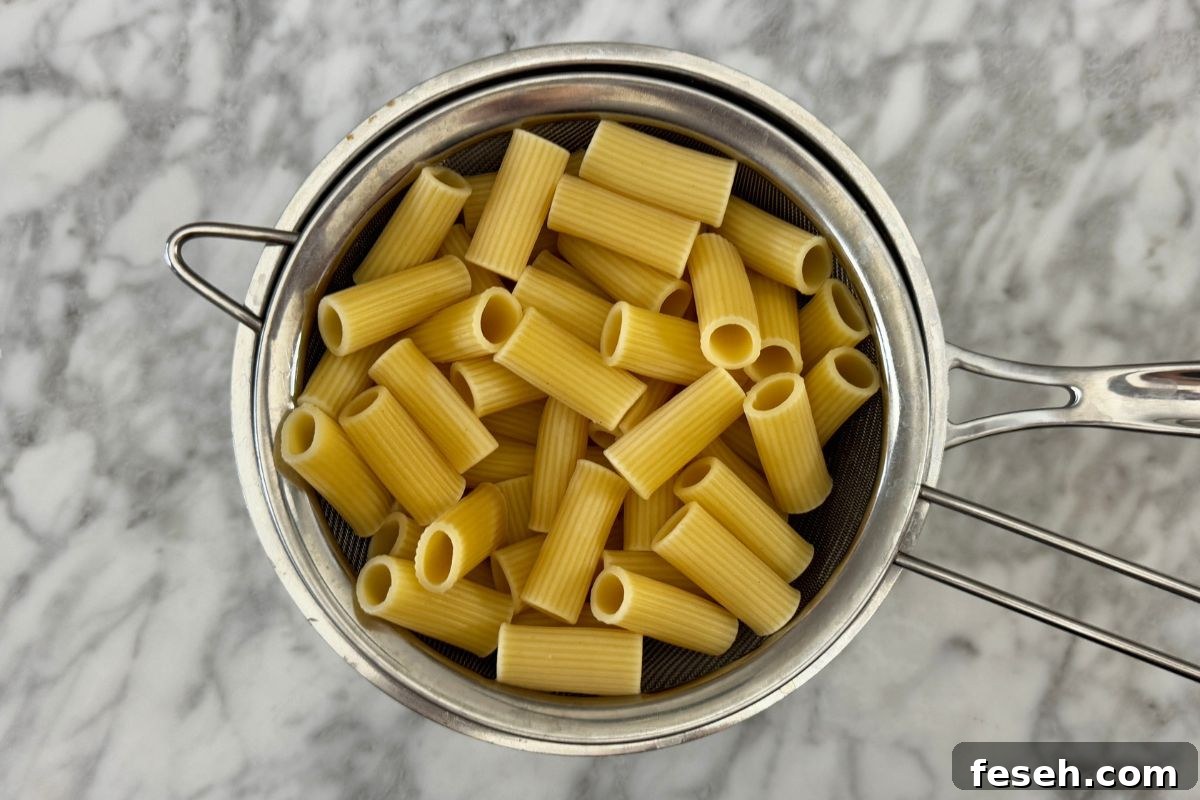 Cooked pasta in a strainer.