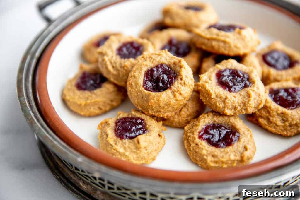 Raspberry Almond Thumbprint cookies on a serving platter.