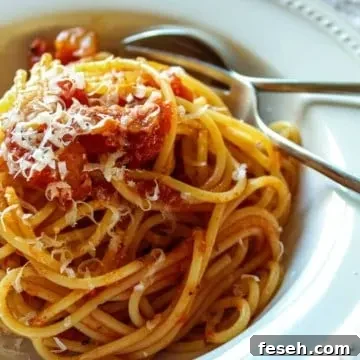 Plated in serving bowl with grated cheese.