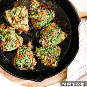 chimichurri chicken thighs in cast iron skillet.