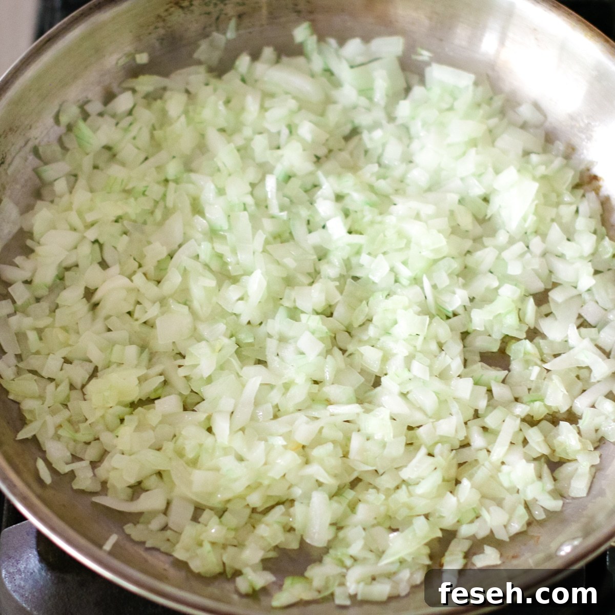 sautéing onions in a pan.