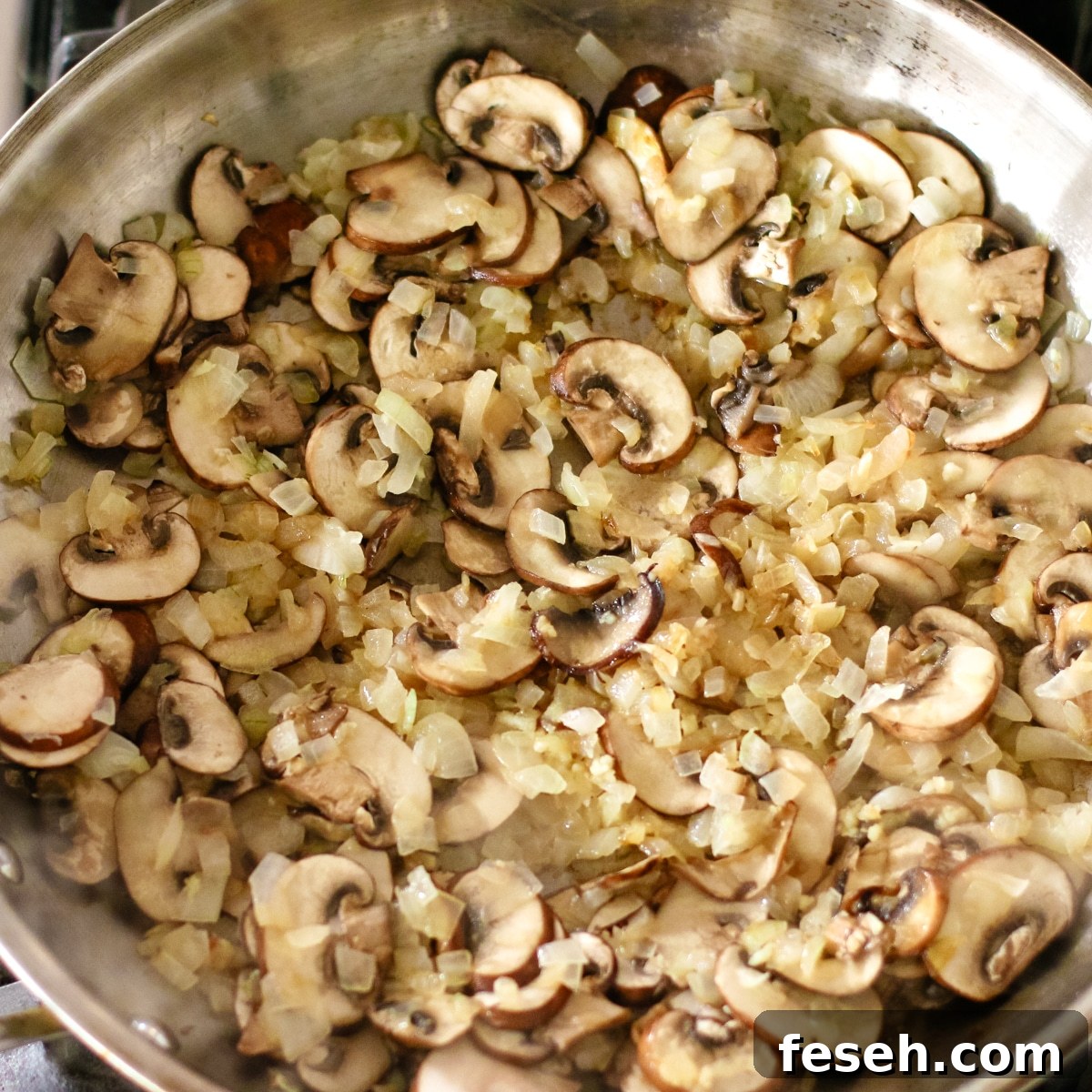 sautéed mushrooms and onions in a pan.