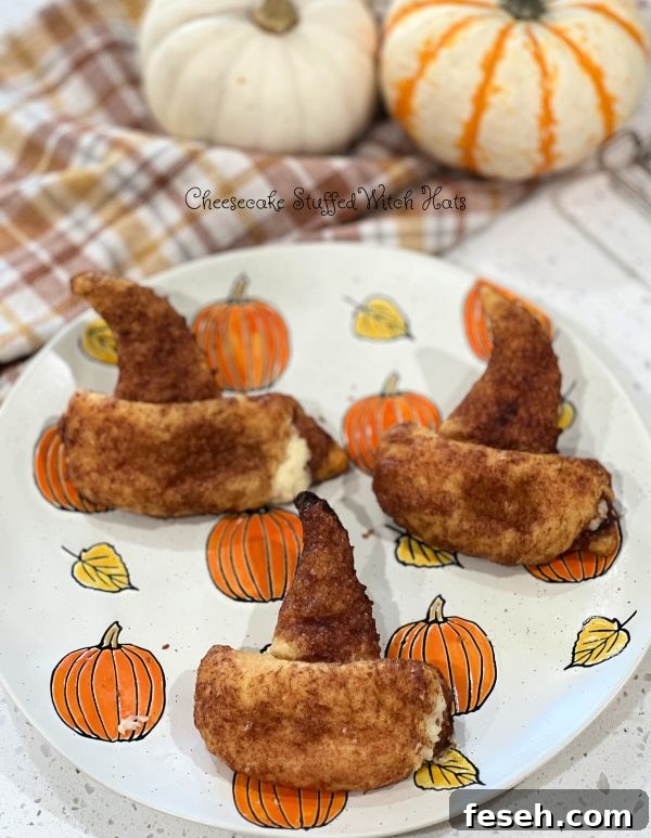 Cheesecake Stuffed Witch Hats on a pumpkin plate with a plaid towel with 2 pumpkins sitting on it