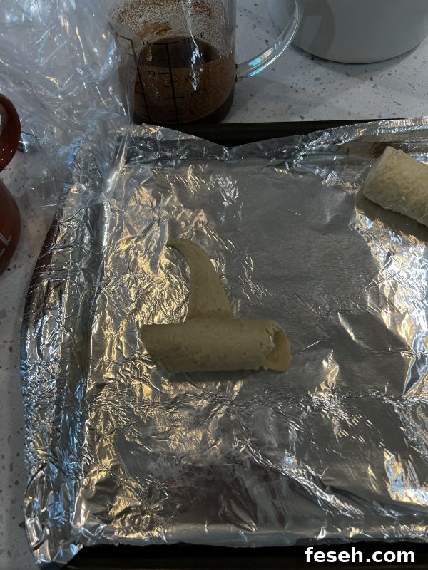 Cheesecake Stuffed Witch Hats being rolled up on a cookie sheet