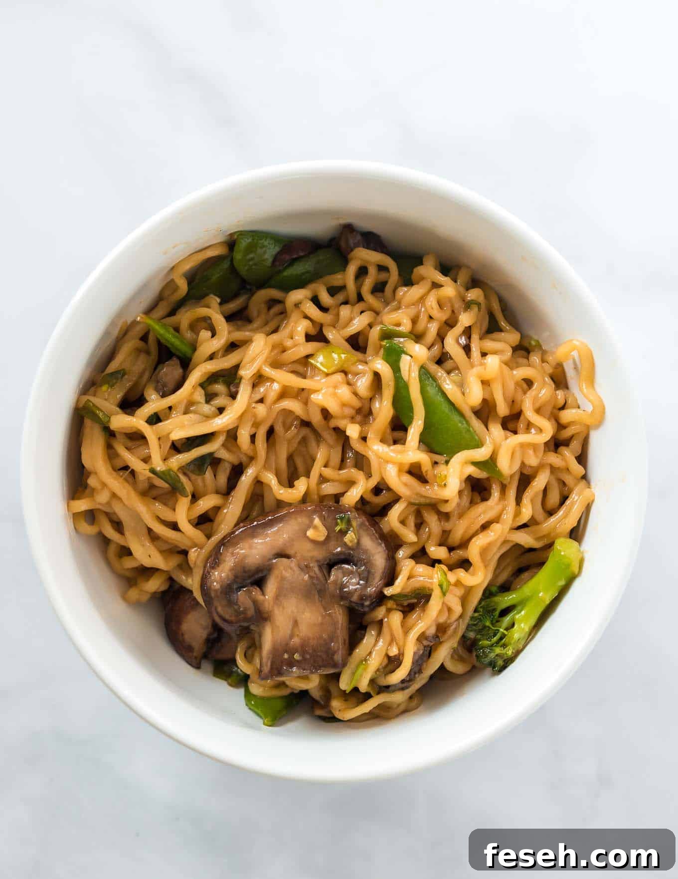 ramen noodles with vegetables in a white bowl